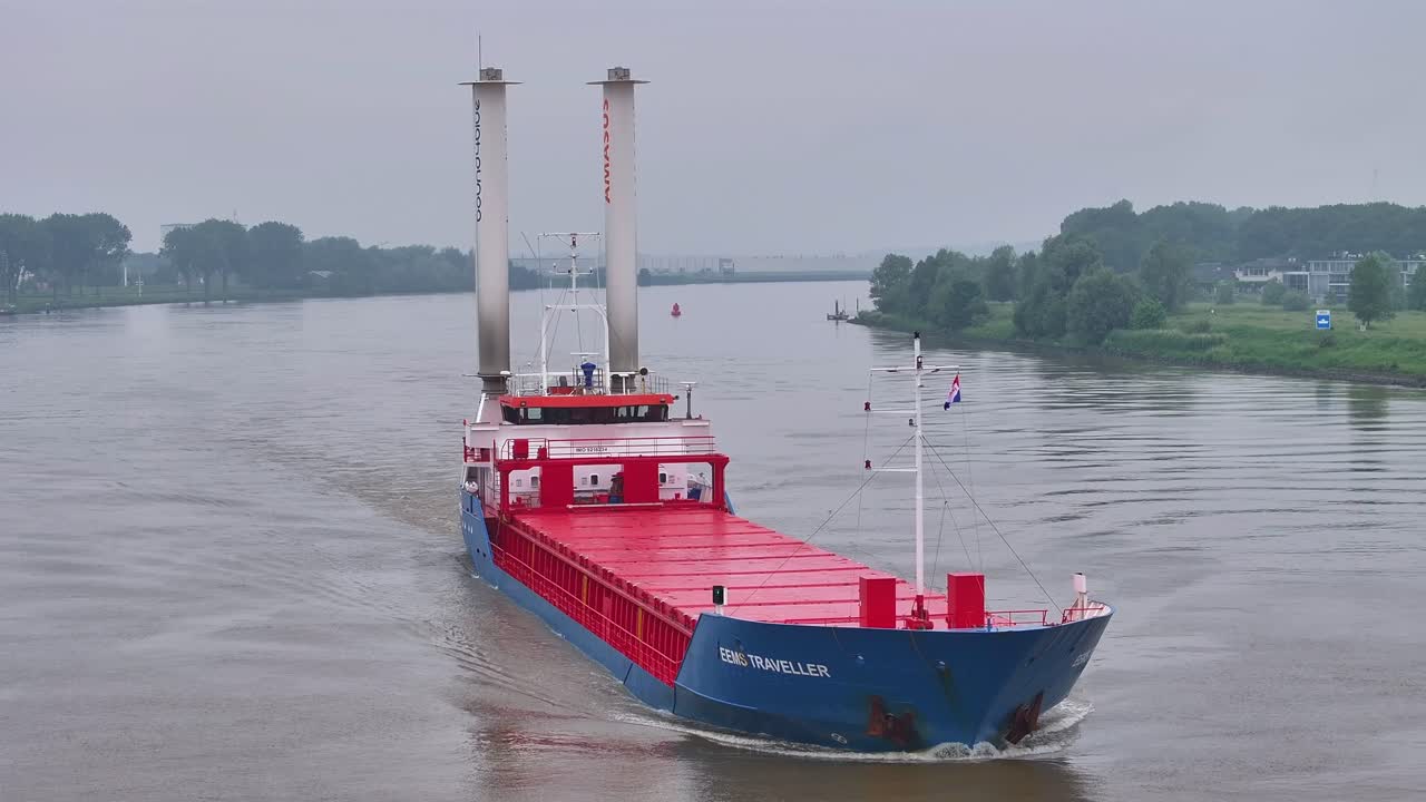 EMIC TRAVELLER Cargo Ship with Flettner Rotors Navigating a Waterway
