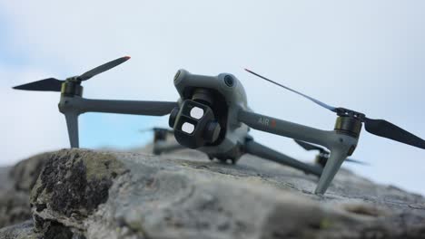 Powering-up-DJI-Air-3-modern-sophisticated-drone-on-rock