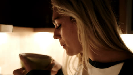 woman having a coffee in kitchen 4k