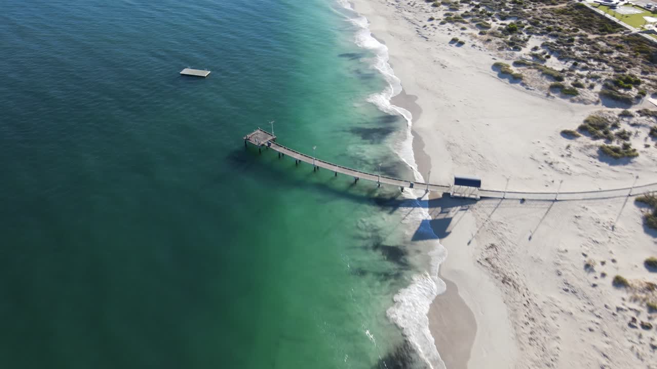 Drone aerial over curved pier and pontoon in Jurien Bay