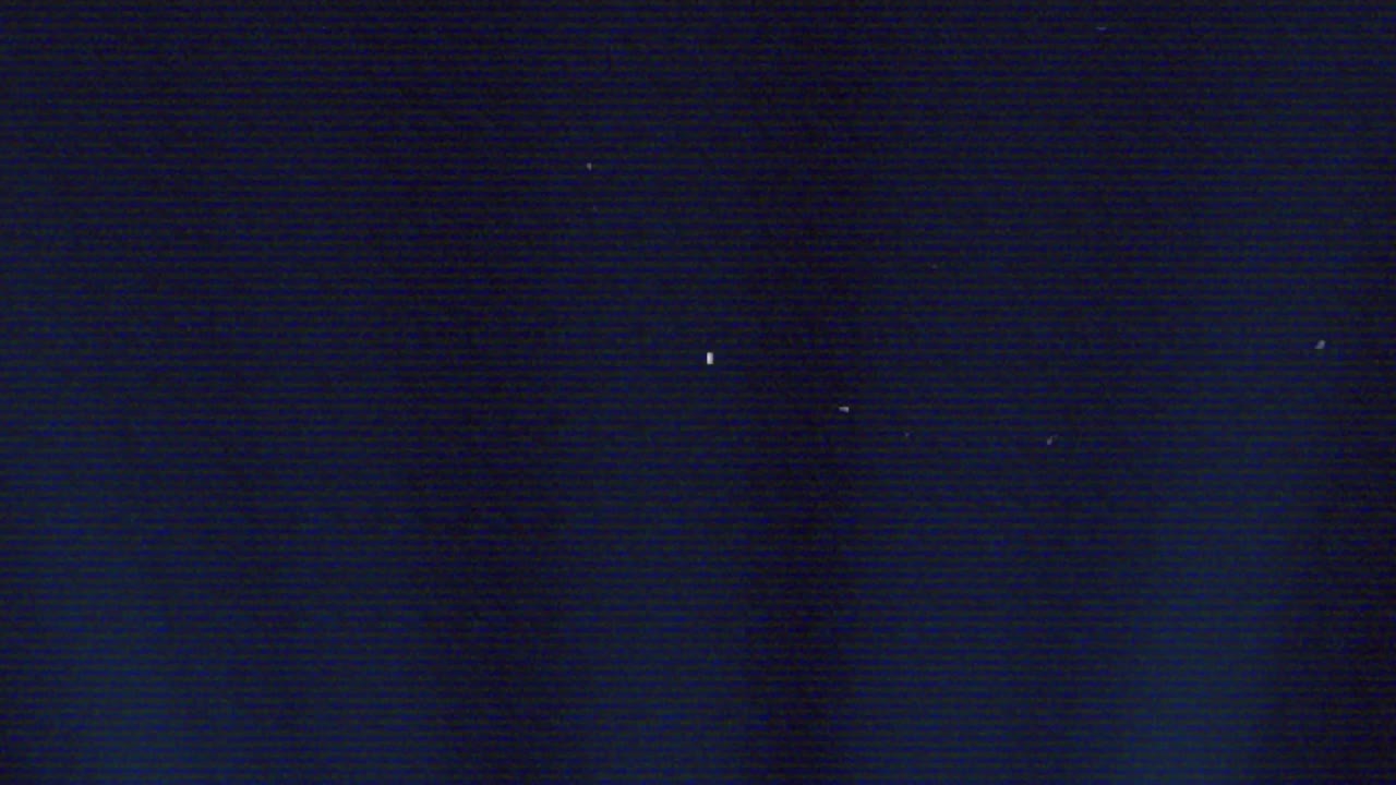 Signal glitch causing grainy navy field shifting scan lines and specks fading, showing artifacts