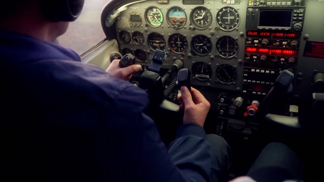 A pilot is flying a propeller plane, taking the wheel, landing the aircraft, jet, indicators, cinematic shot