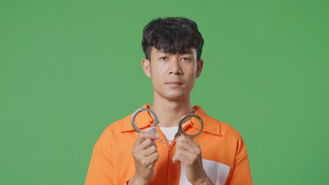 man in orange jumpsuit with handcuffs