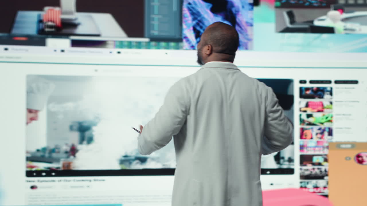 Vertical video Smiling man using phone gains access to thousands of videos with press of button