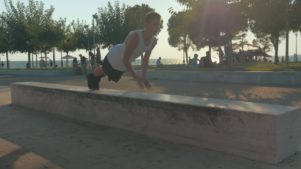 Teenager performing push-ups on waterfront