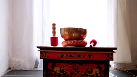 buddhist hotel with red and black furniture and various religious tools