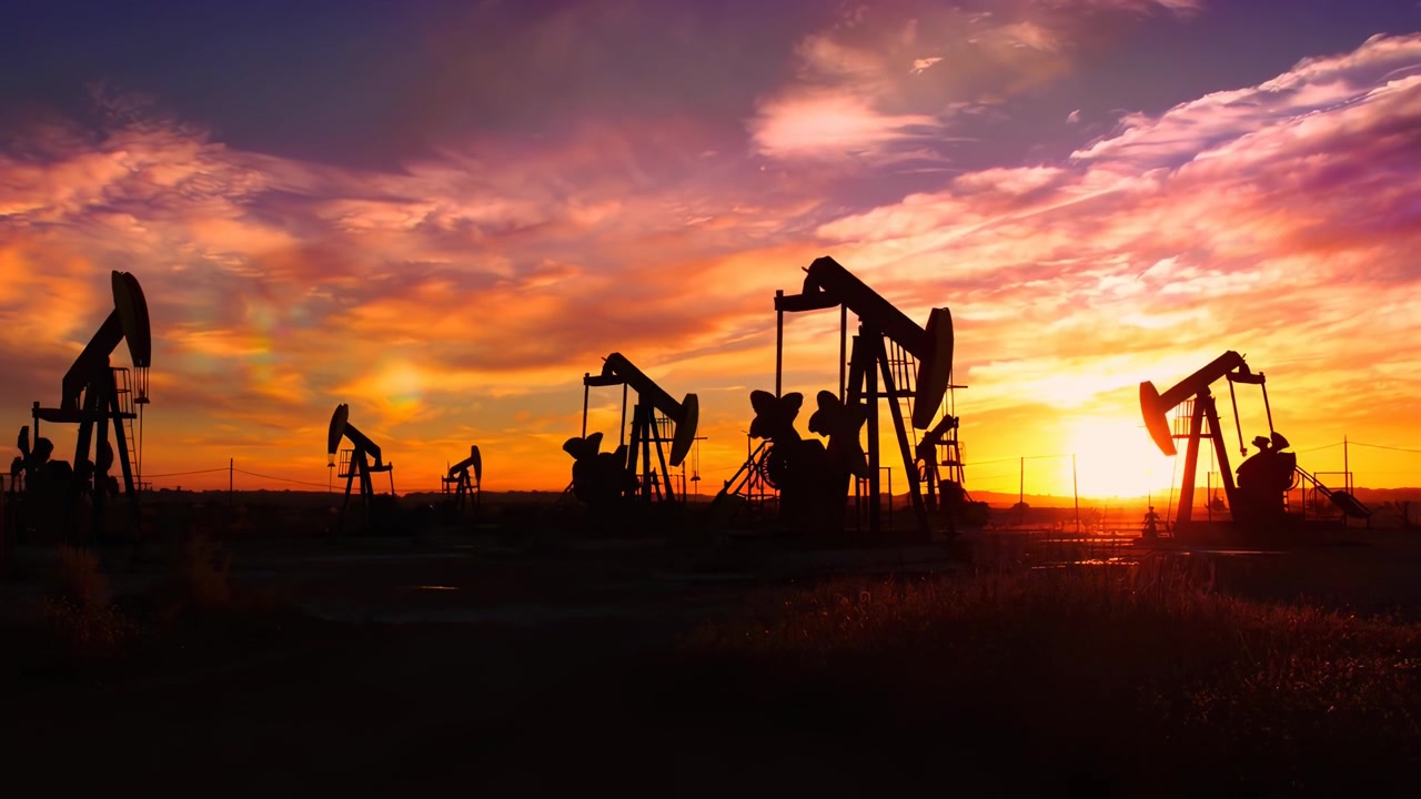Time Lapse of Oil Pumpjacks Pumping Against a Changing Sky