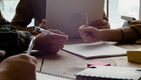 Close-Up-View-Of-The-Hands-Of-A-Group-Of-Students-1