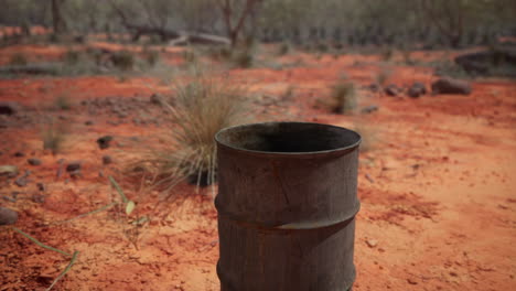 old empty rusted barrel on sand