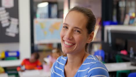 side view of caucasian female teacher smiling in the classroom 4k