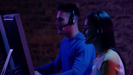 Woman-and-man-working-together-at-computers