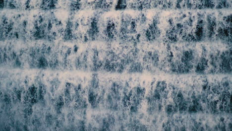 Close-Up-of-water-flowing-down-a-reservoir-dam-in-New-York