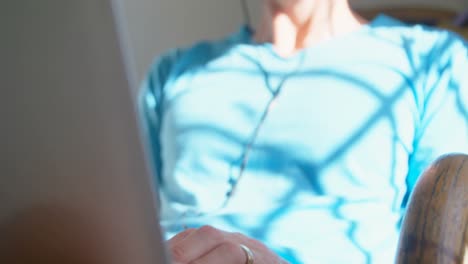 Man-using-laptop-with-headphones-4k