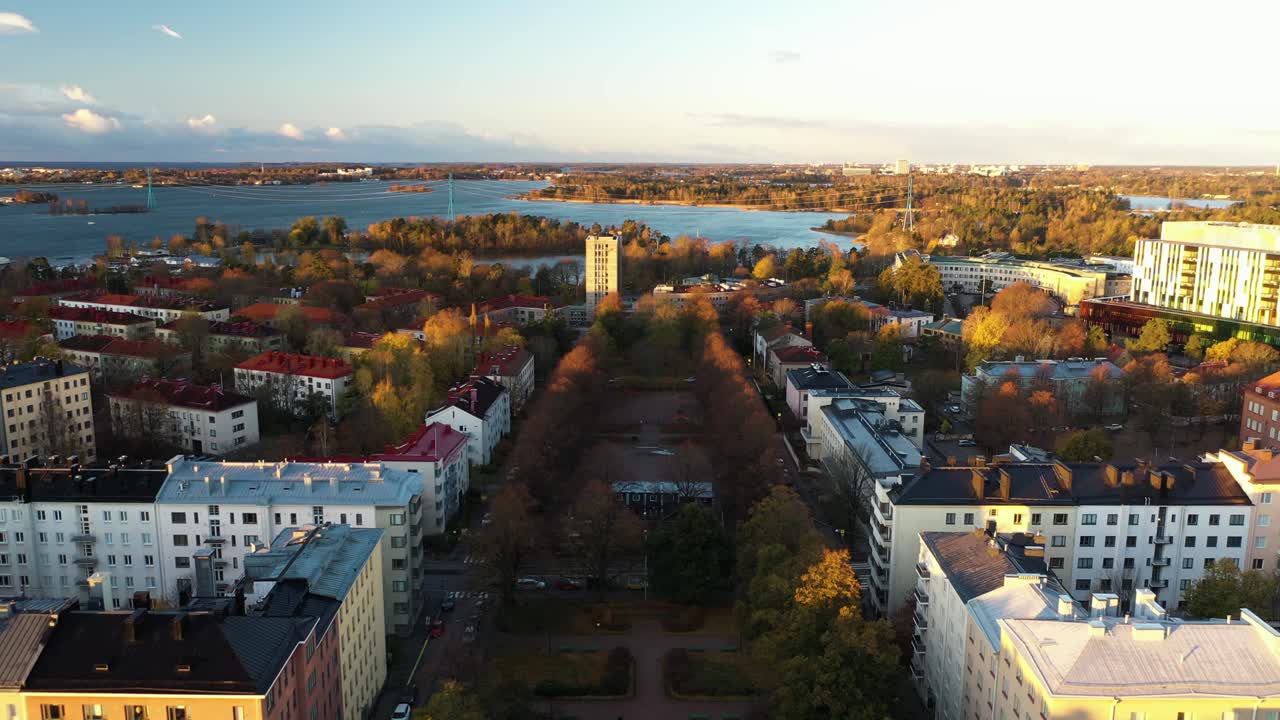 Aerial view flying over the cityscape of Toolo, sunny, fall evening in Helsinki