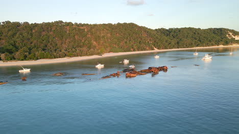 moreton island beach coast, tangalooma shipwreck aerial drone view, white sand beach with green cliffs