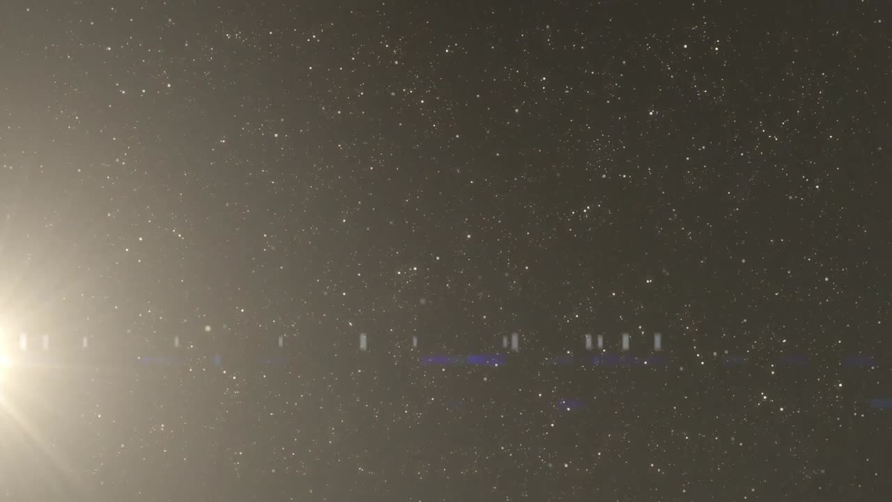 검은 바탕에  점 위에 렌즈 플레어의 애니메이션