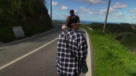 woman walking on a mountain road