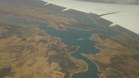 a extremely high shot, from a plane, of a extrange lake in a dry land