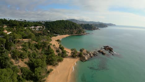 Descubra-Las-Joyas-Ocultas-De-Las-Vistas-Aéreas-De-Lloret-De-Mar,-Destacando-La-Pintoresca-Belleza-De-Santa-Cristina-Y-Cala-Treumal-A-Lo-Largo-De-Su-Costa.