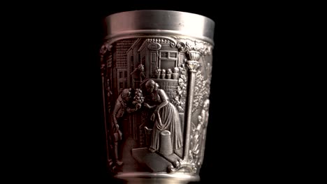 vintage pewter alloy cups with carved details, close up