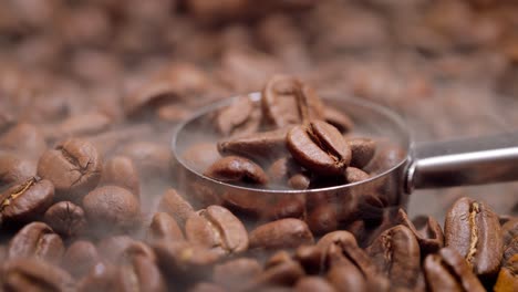 Close-up-of-seeds-of-coffee.-Fragrant-coffee-beans-are-roasted-smoke-comes-from-coffee-beans.