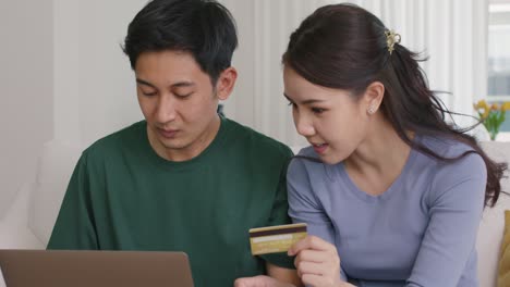 happy asian man and woman booking ticket online app from retail store.