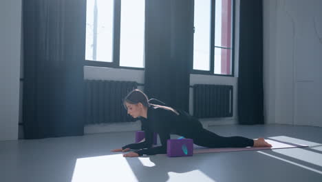 woman doing yoga stretches with blocks