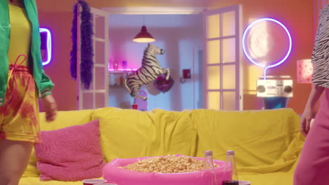 two friends enjoying popcorn and a movie