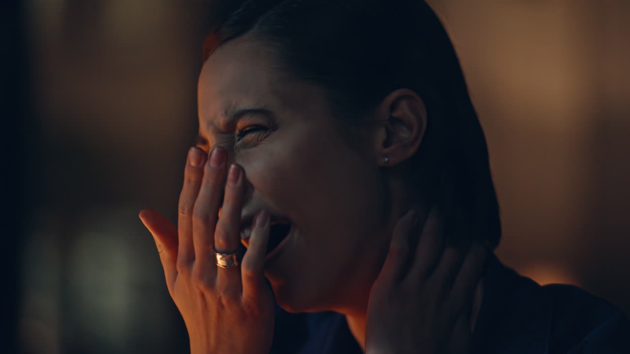 Closeup overworked freelancer massaging neck at dark apartment workplace