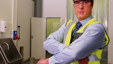 Portrait-of-inspection-officer-standing-with-arms-crossed