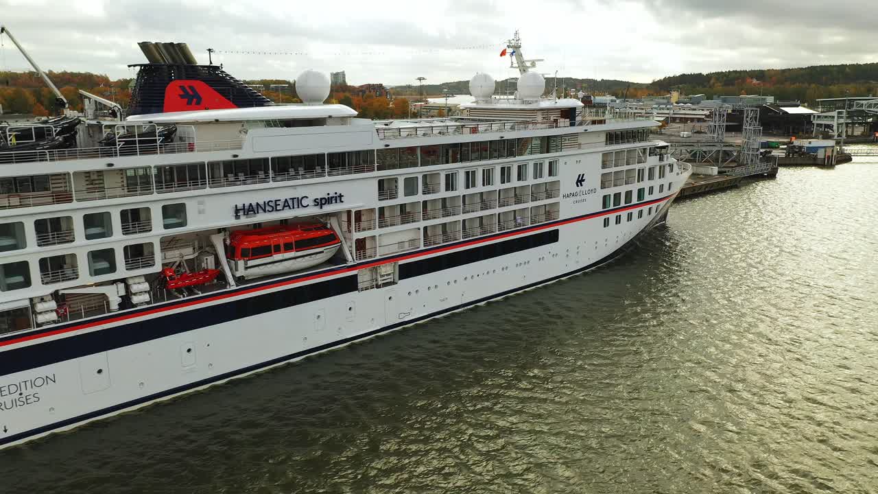 Aerial side view moving stern to bow of cruise vessel Hanseatic Spirit while alongside at Port of Turku. This was the first cruise vessel to arrive since Covid-19 suspended all cruises.
