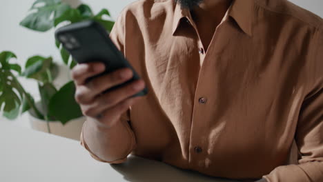 Focused-businessman-calling-cellphone-in-office.-Young-man-answering-phone-call