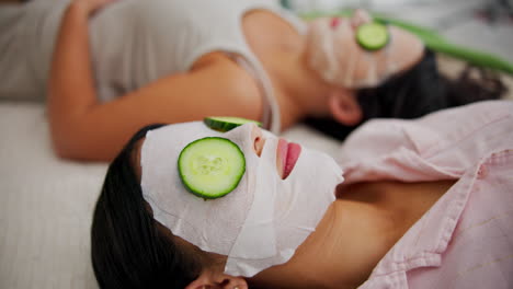 women relaxing with face masks and cucumbers