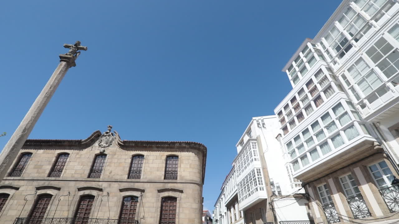 Old stone building and modern white facade with a clear blue sky in a European city