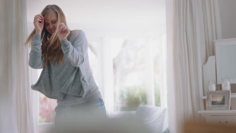 happy-young-woman-dancing-at-home-celebrating-weekend-having-fun-dance-in-bedroom-wearing-pajamas-in-morning-enjoying-new-day-4k-footage