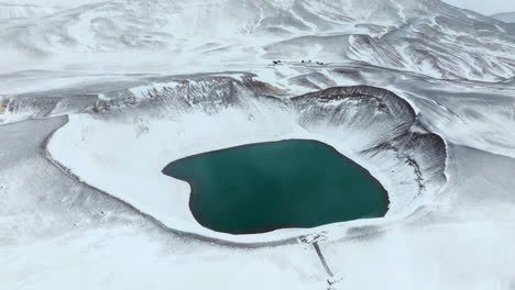 el lago del cráter de kraftla cubierto de nieve durante el invierno en el norte de islandia - fotografía aérea