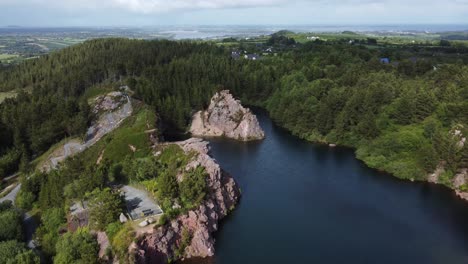 Beautiful-lowering-aerial-shot-of-old-Irish-quarry-as-clouds-pass-overhead