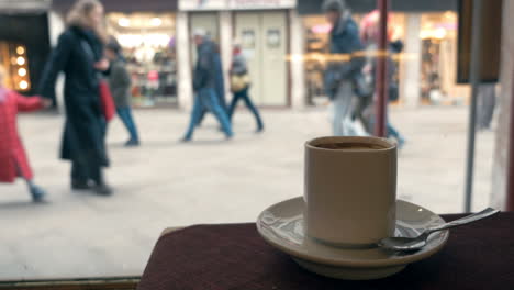 woman having coffee by the window in cafe