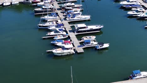 private yachts docked in marina, aerial view