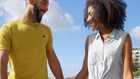 Couple-waking-hand-in-hand-at-beach-4k