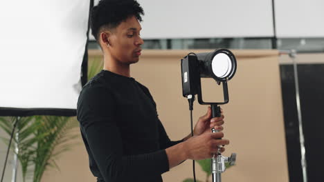 photographer adjusting studio lighting