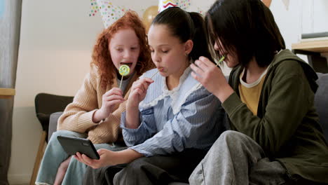 girls licking lollipops