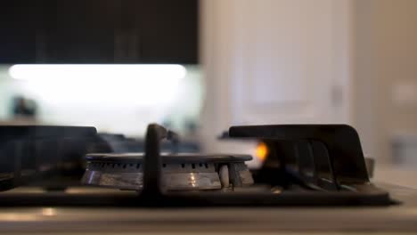capturing the transition: a gas burner ignites brightly, signifying the beginning of a culinary journey in a modern kitchen setting