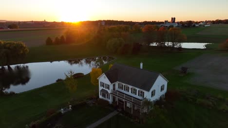 Family-farm-with-pond-at-sunset