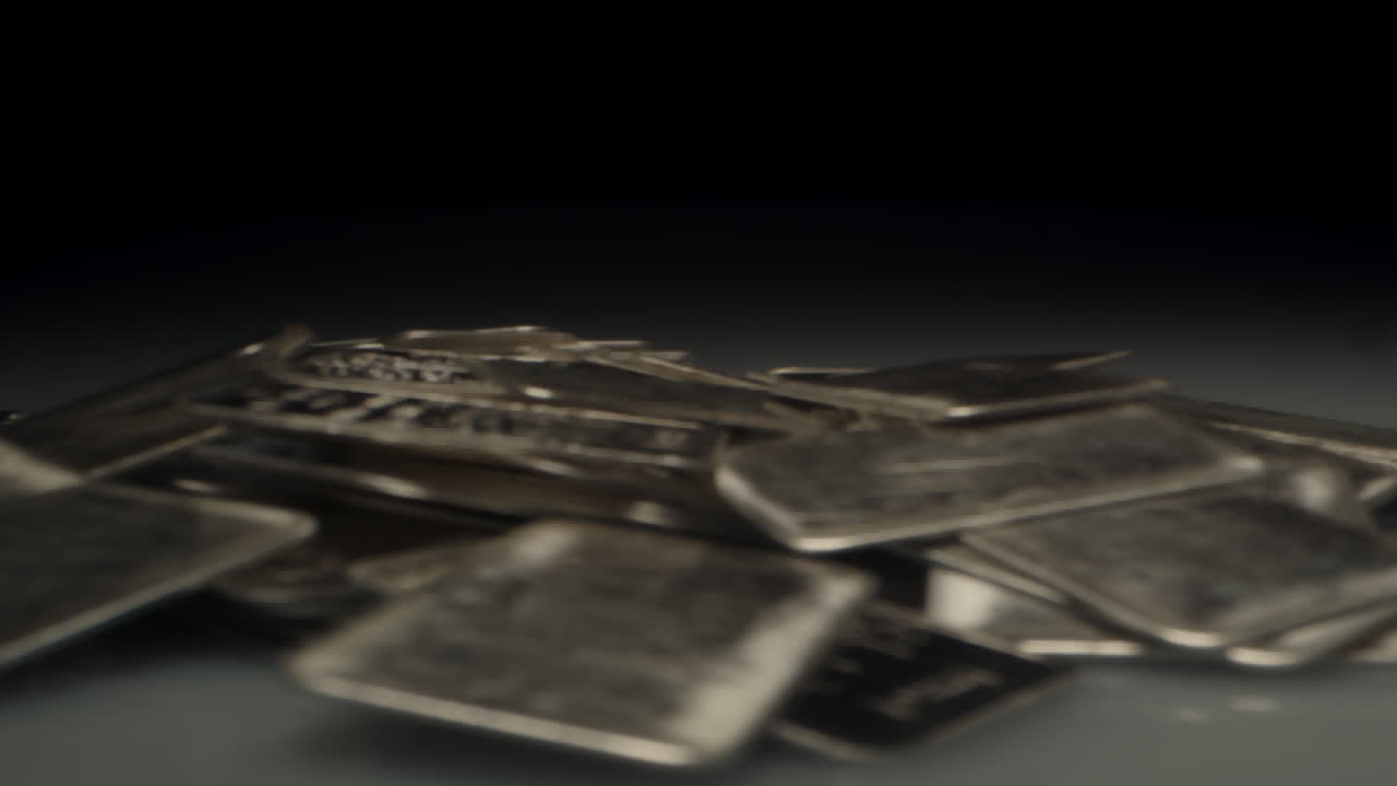 Cinematic macro dolly out of a large amount of silver bars piled up in a dark room