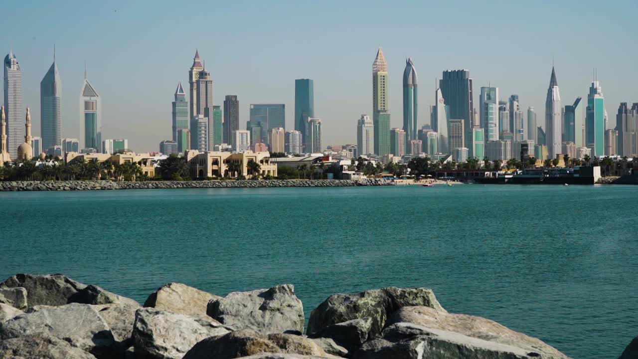 Emirates Towers As Seen From Rocky Beach In Dubai, UAE