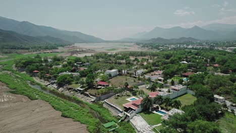 aerial - city and surrounding mountains, santiago, nuevo león, mexico, spinning shot