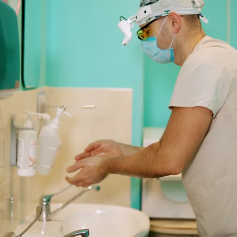 doctor washes hands with soap. male surgeon washing hands before hospital operation
