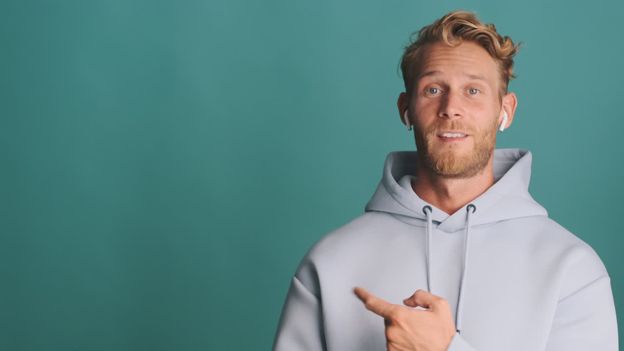 Bearded guy pointing aside and giving thumbs up