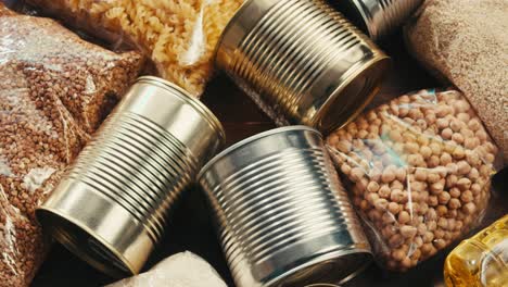Canned cereals beans fish and vegetables, an assortment of processed foods, supermarket cart online shopping, delivery.